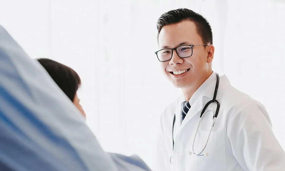 A doctor speaking with a seated person