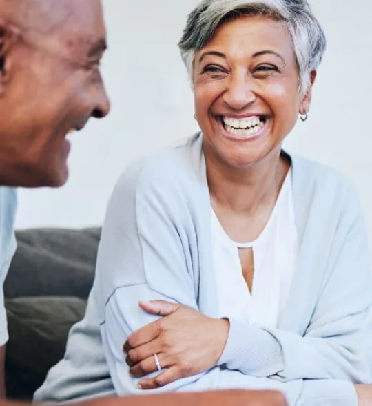 An older woman smiling during a conversation
