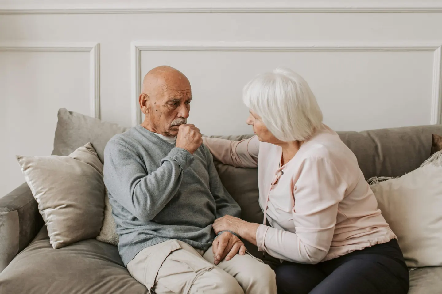 An older couple sitting together on a sofa