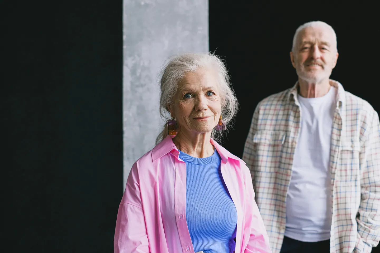 An older couple standing side by side