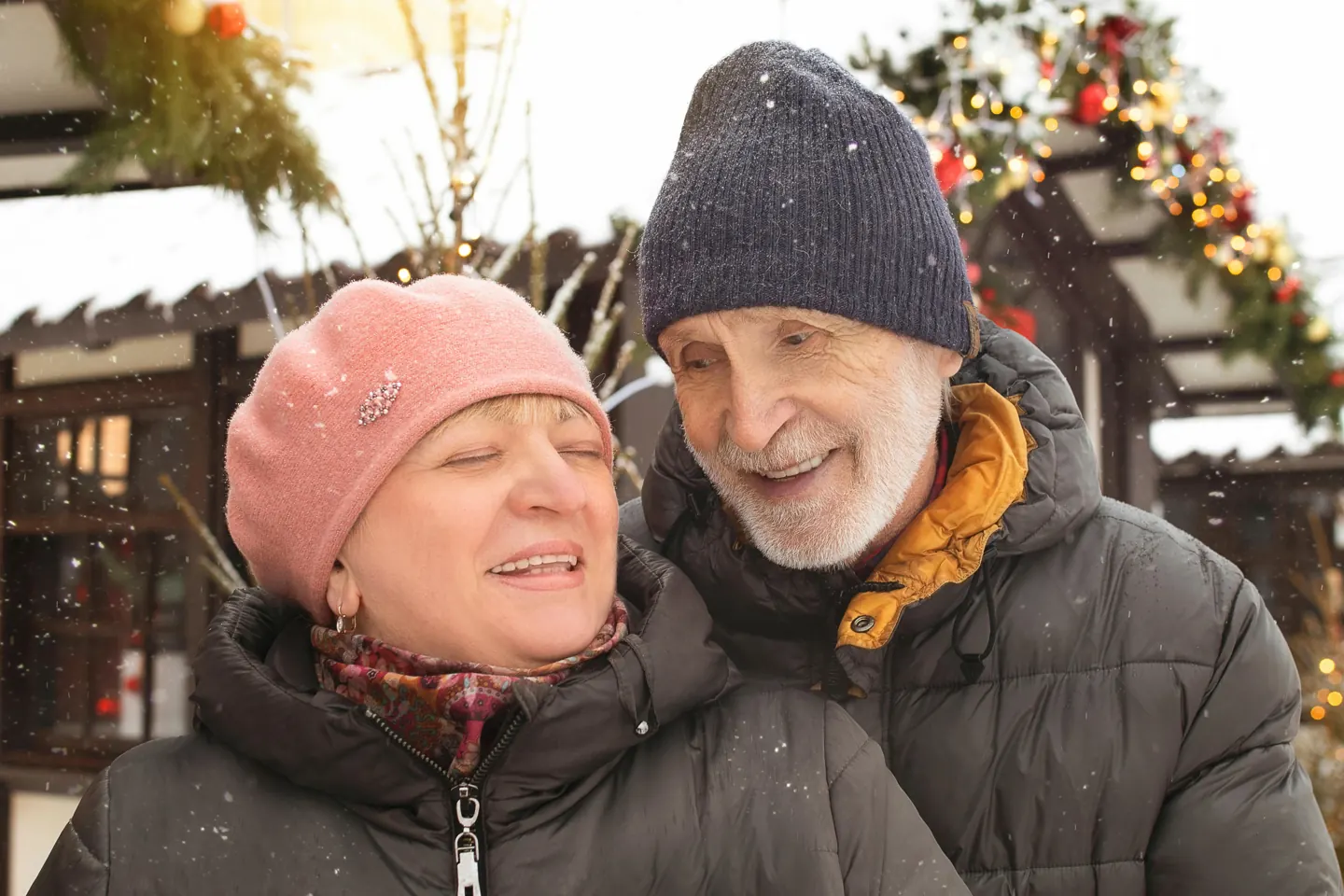 An older couple wearing winter hats outdoors