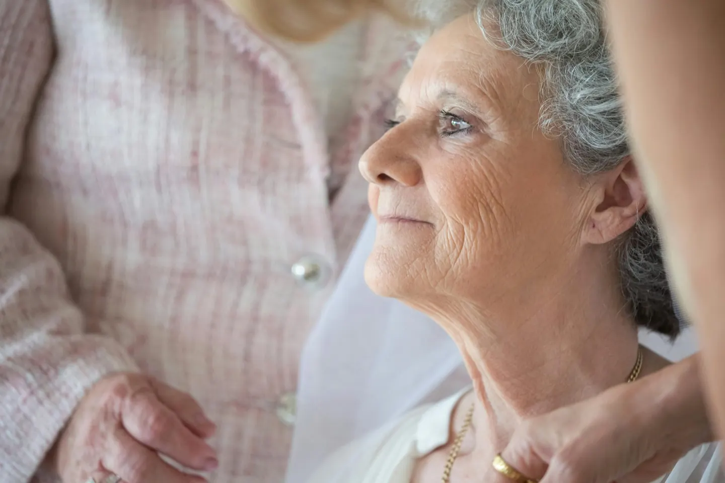 An older woman looking up at someone beside her