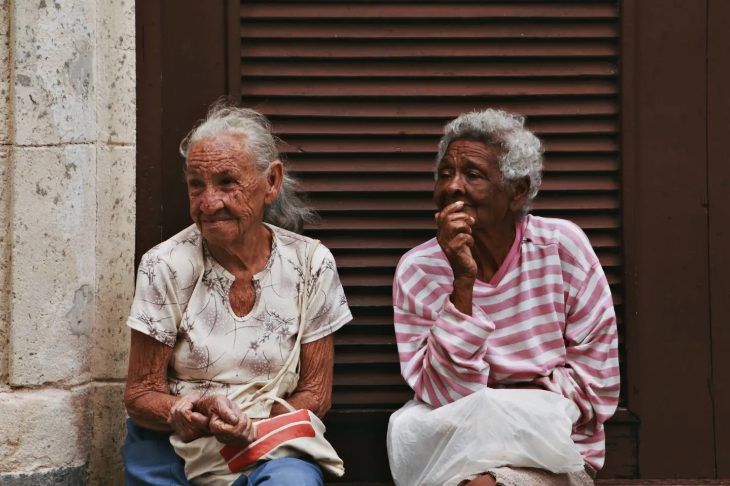 Two older women sitting outside and talking